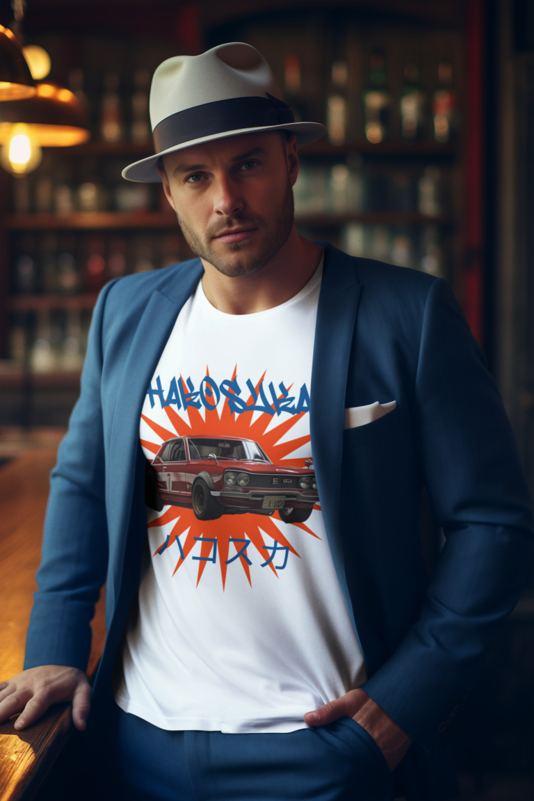 Man wearing a Hakosuka Skyline T-shirt and stylish blue jacket, standing confidently with a casual pose